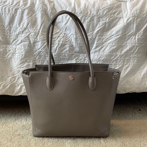 Little Unicorn tote diaper bag, light grey with white/ grey stripe inside.